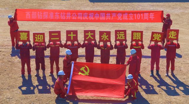 2022年6月22日，准东钻井公司70606钻井队干部员工簇拥在党旗周围祝福建党101周年生日快乐。.JPG